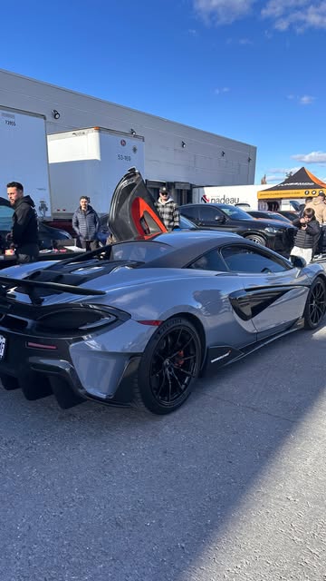Grey McLaren 600LT with its dihedral door open.